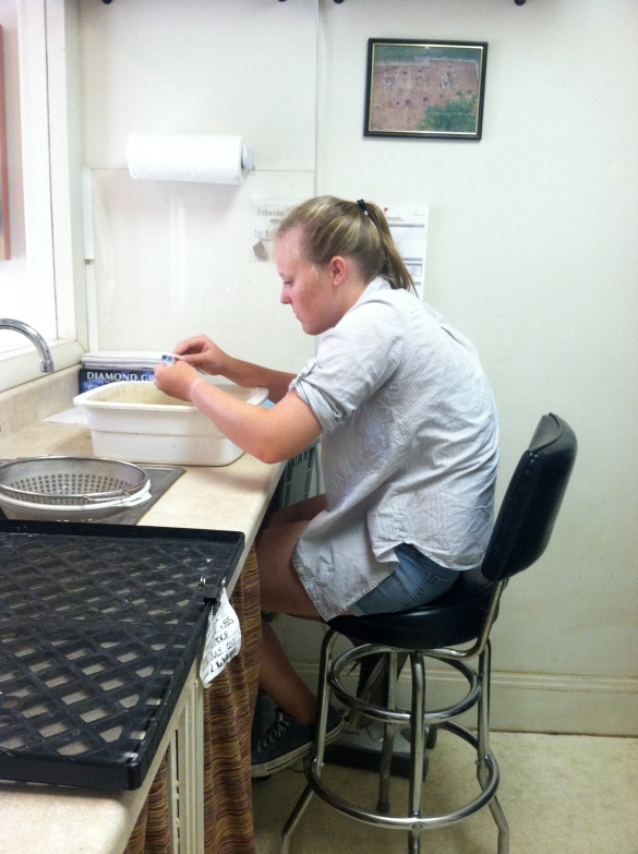  Lauren washes artifacts in the lab on Tuesday.